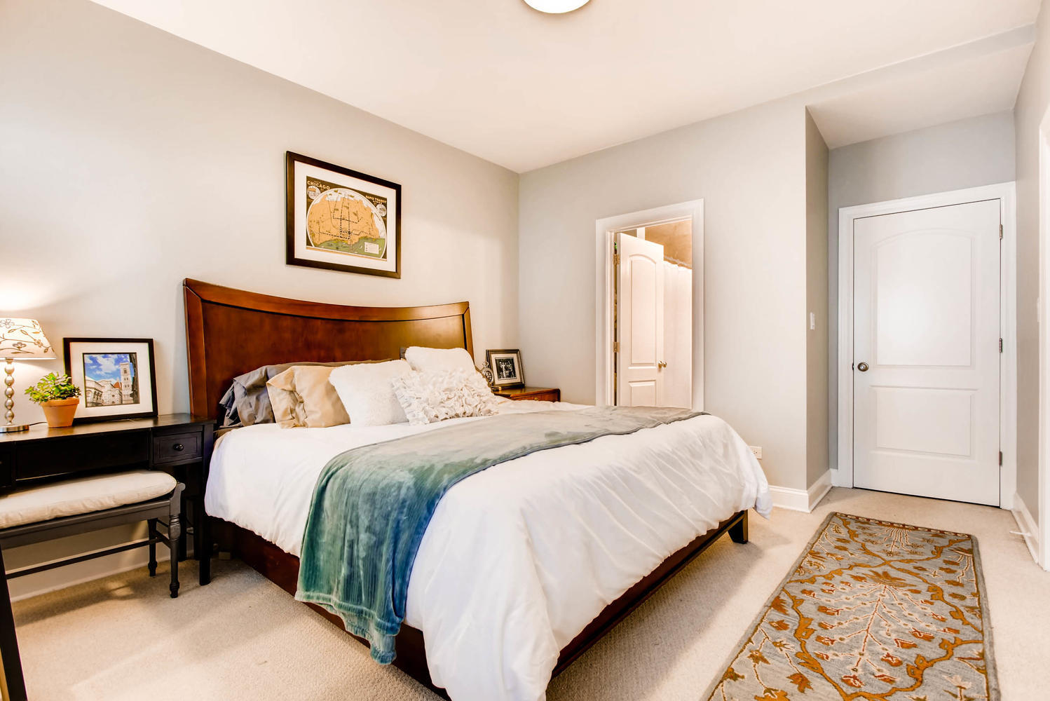 1242 West Pratt Boulevard, Unit 3F Chicago, IL 60626 - Photo 15 of 30 a bedroom with a bed and a painting on the wall