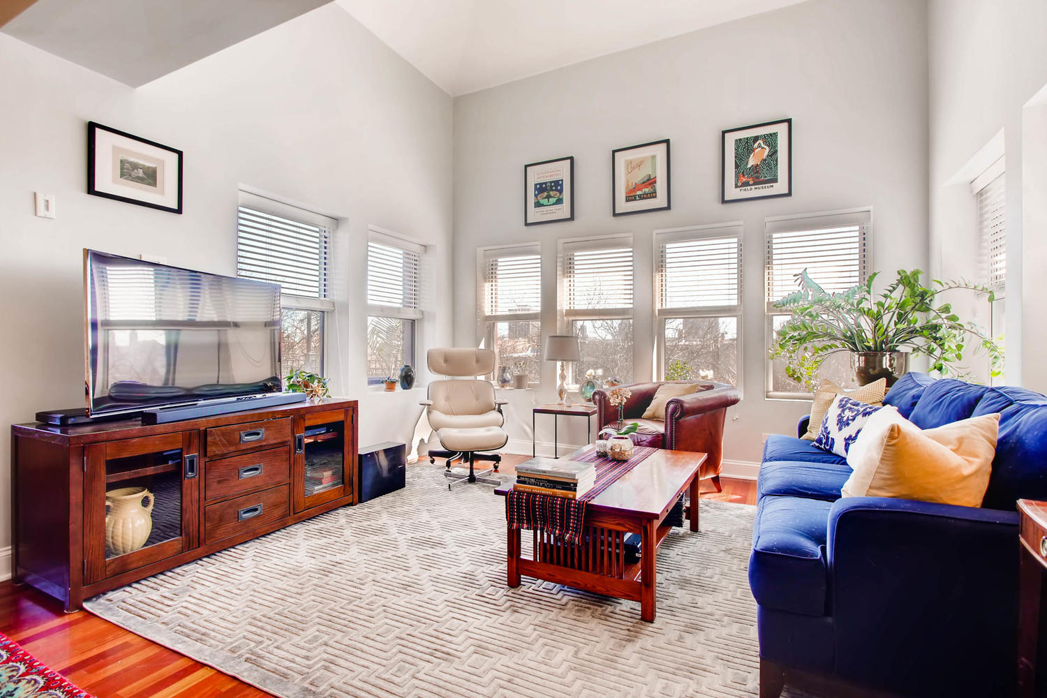1242 West Pratt Boulevard, Unit 3F Chicago, IL 60626 - Photo 3 of 30 a living room with furniture a large window and a flat screen tv
