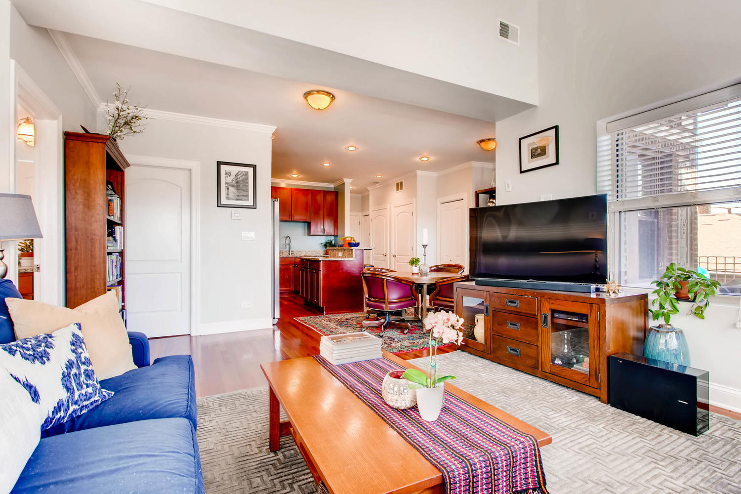 1242 West Pratt Boulevard, Unit 3F Chicago, IL 60626 - Photo 4 of 30 a living room with furniture and a flat screen tv