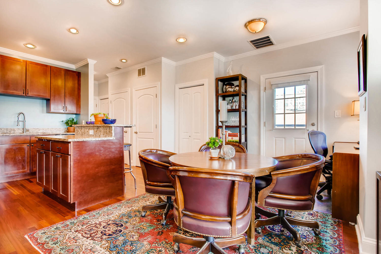 1242 West Pratt Boulevard, Unit 3F Chicago, IL 60626 - Photo 7 of 30 a room with stainless steel appliances kitchen island granite countertop a dining table chairs and a refrigerator