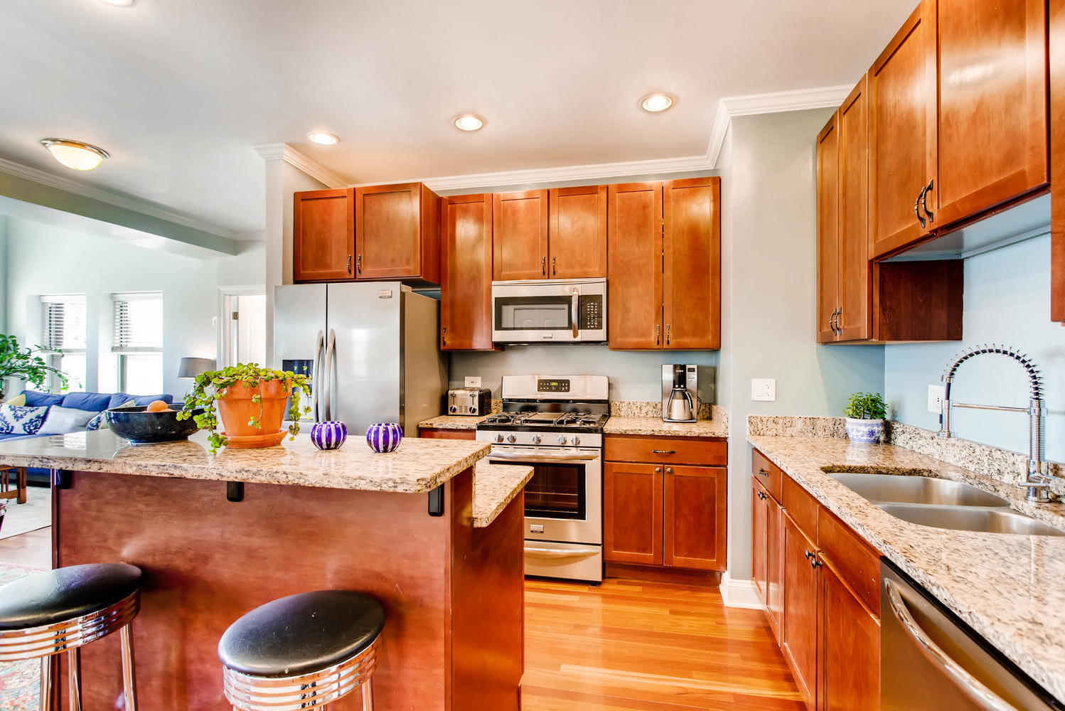 1242 West Pratt Boulevard, Unit 3F Chicago, IL 60626 - Photo 9 of 30 a kitchen with a sink a stove and chairs