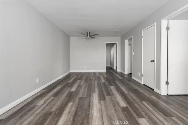 a view of a room with wooden floor and white walls