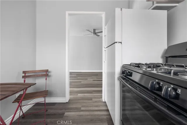 a kitchen with a stove and a refrigerator