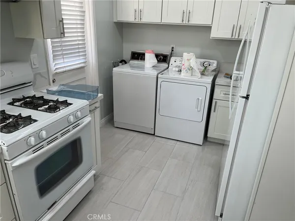 a view of a storage and utility room with washer and dryer