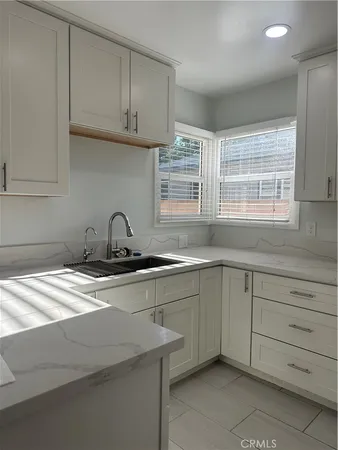 a kitchen with a sink and cabinets