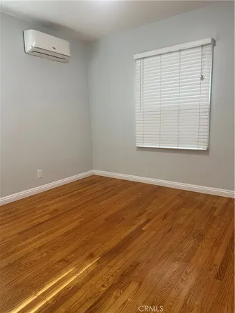 a view of a room with wooden floor and windows