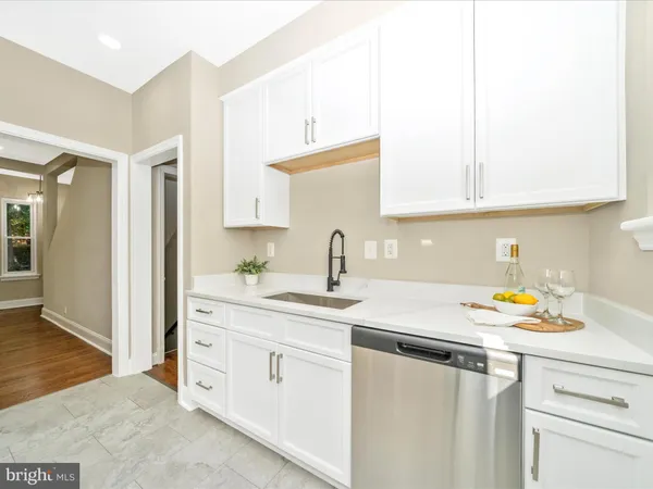 a kitchen with a refrigerator a sink and a stove top oven