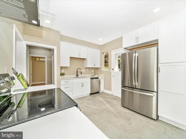 a kitchen that has a table and chairs in it
