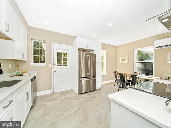a kitchen with stainless steel appliances a refrigerator sink and cabinets