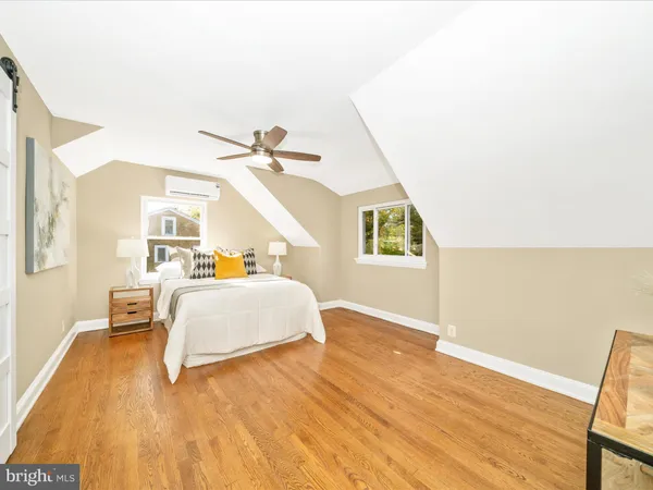 a bedroom with a bed and a wall painting