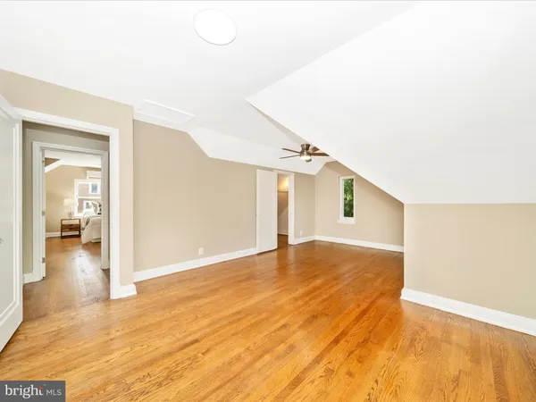 a view of a big room with wooden floor and windows