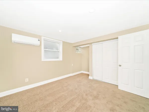 a room with a sink and a mirror