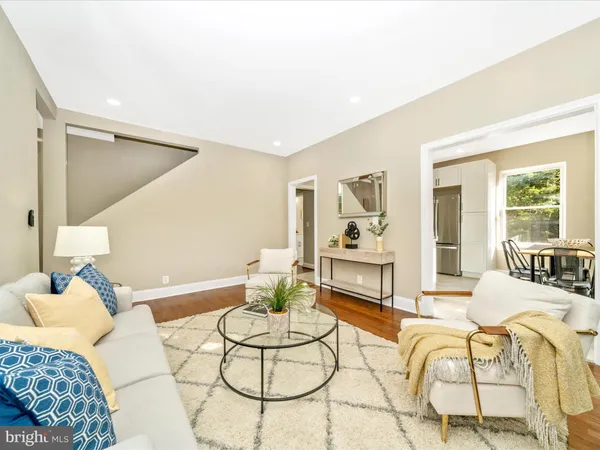 a living room with furniture and a dining table