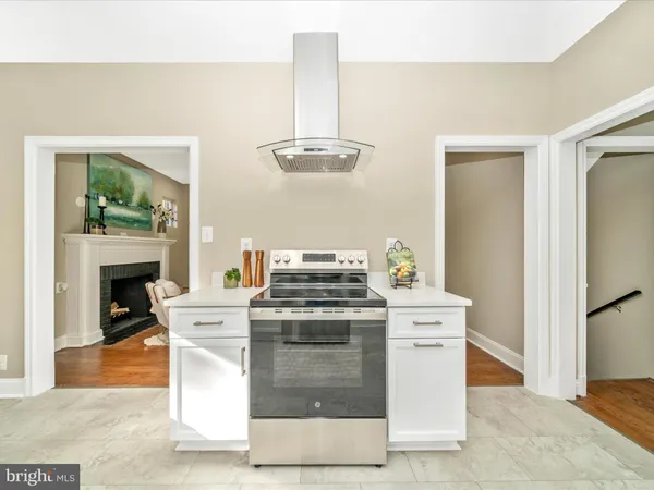 a kitchen with cabinets appliances and a window
