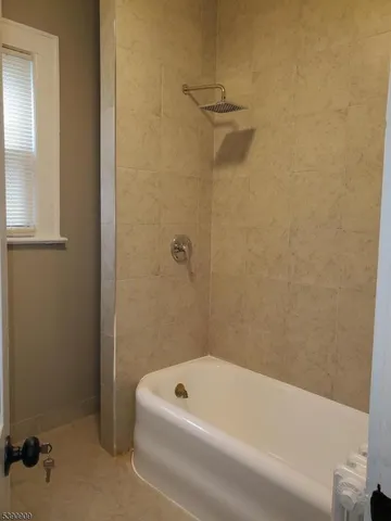 a bathroom with a tub and a shower