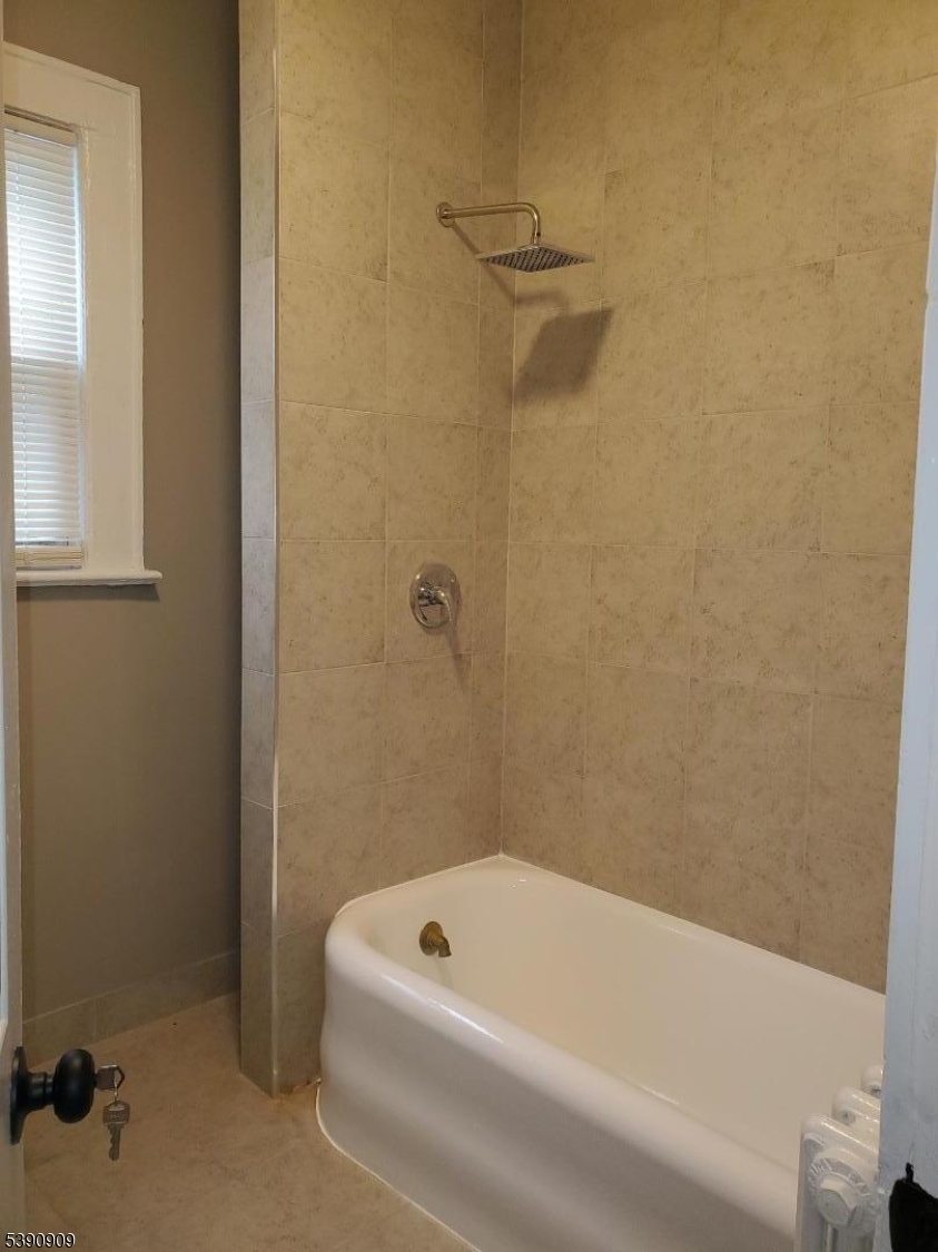 404 North 6th Street, Unit A Newark, NJ 07107 - Photo 11 of 19 a bathroom with a tub and a shower