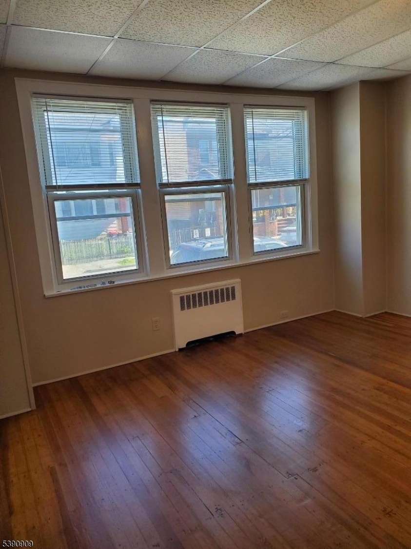 404 North 6th Street, Unit A Newark, NJ 07107 - Photo 14 of 19 an empty room with wooden floor and windows