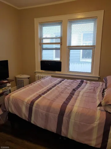 a bedroom with a bed and a mirror