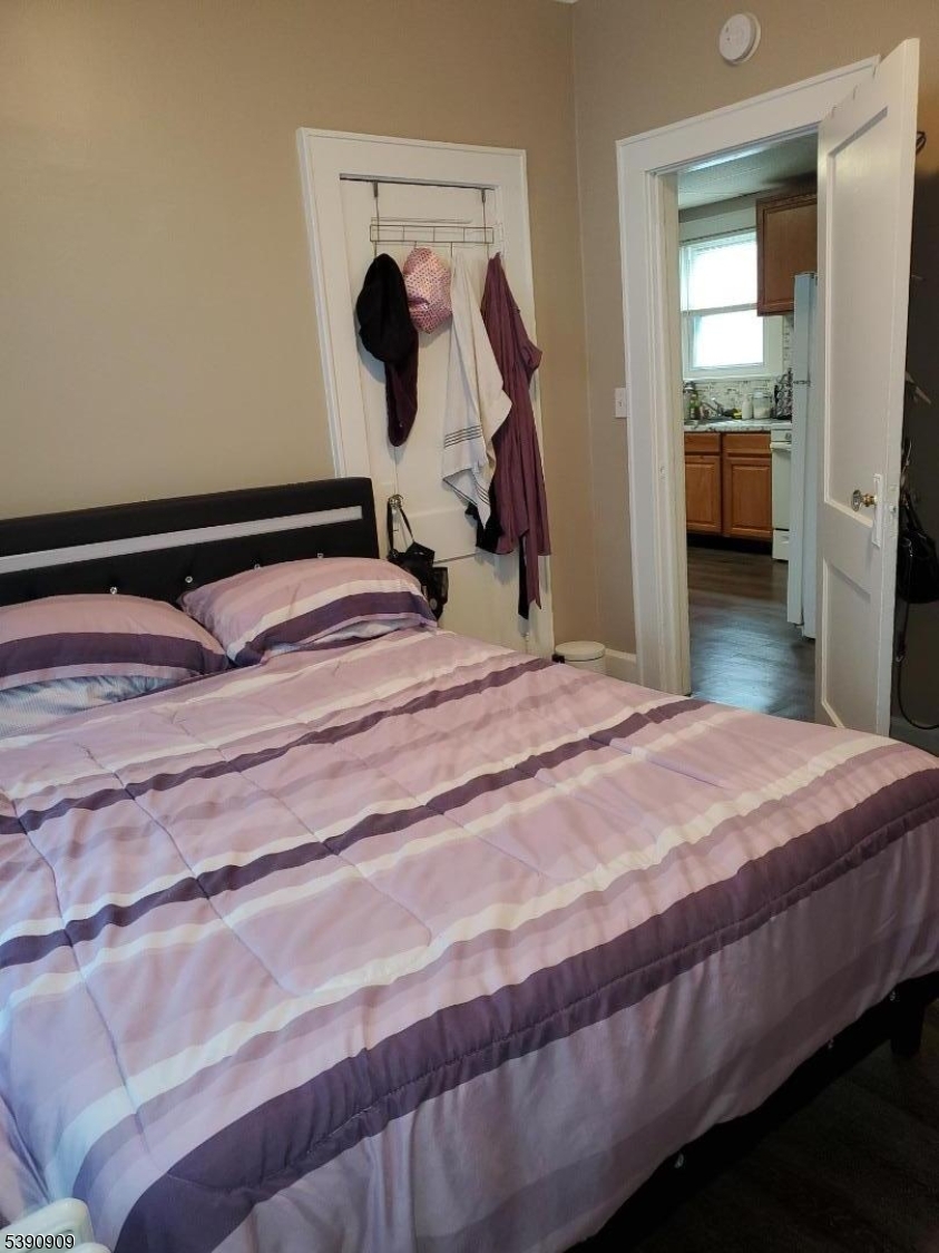 404 North 6th Street, Unit A Newark, NJ 07107 - Photo 18 of 19 a bedroom with a bed and a mirror