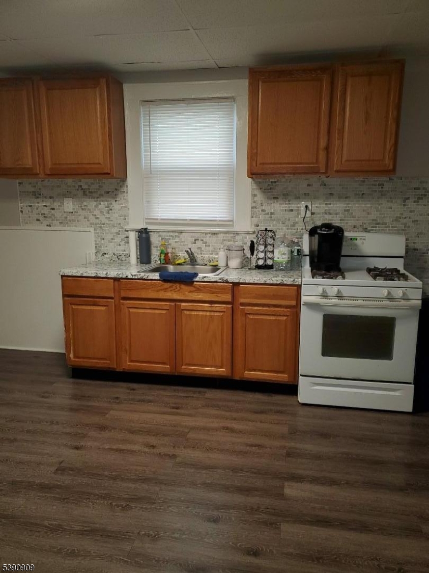 404 North 6th Street, Unit A Newark, NJ 07107 - Photo 2 of 19 a kitchen with stainless steel appliances granite countertop a stove a sink and a microwave