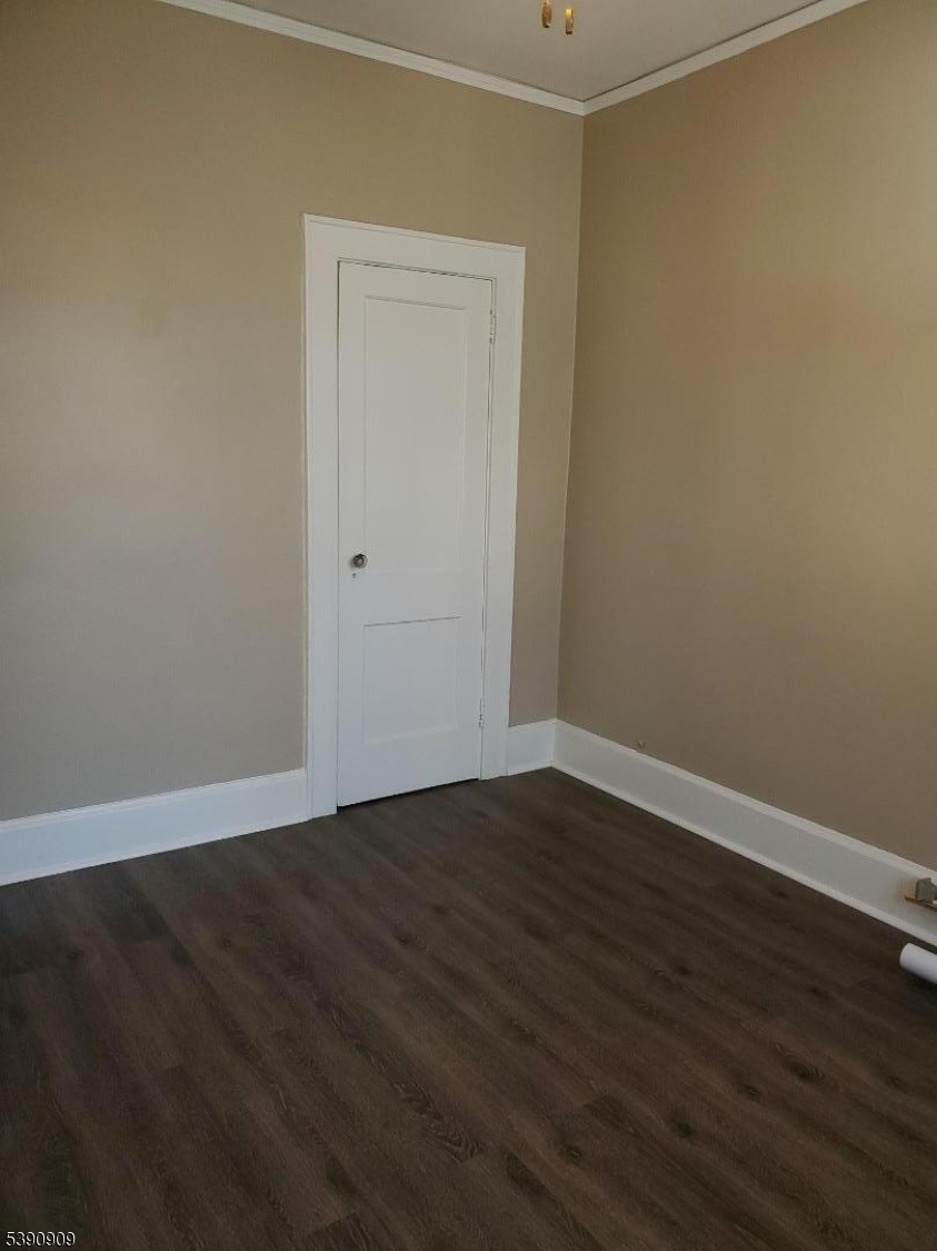 404 North 6th Street, Unit A Newark, NJ 07107 - Photo 10 of 19 a view of an empty room with wooden floor and a window