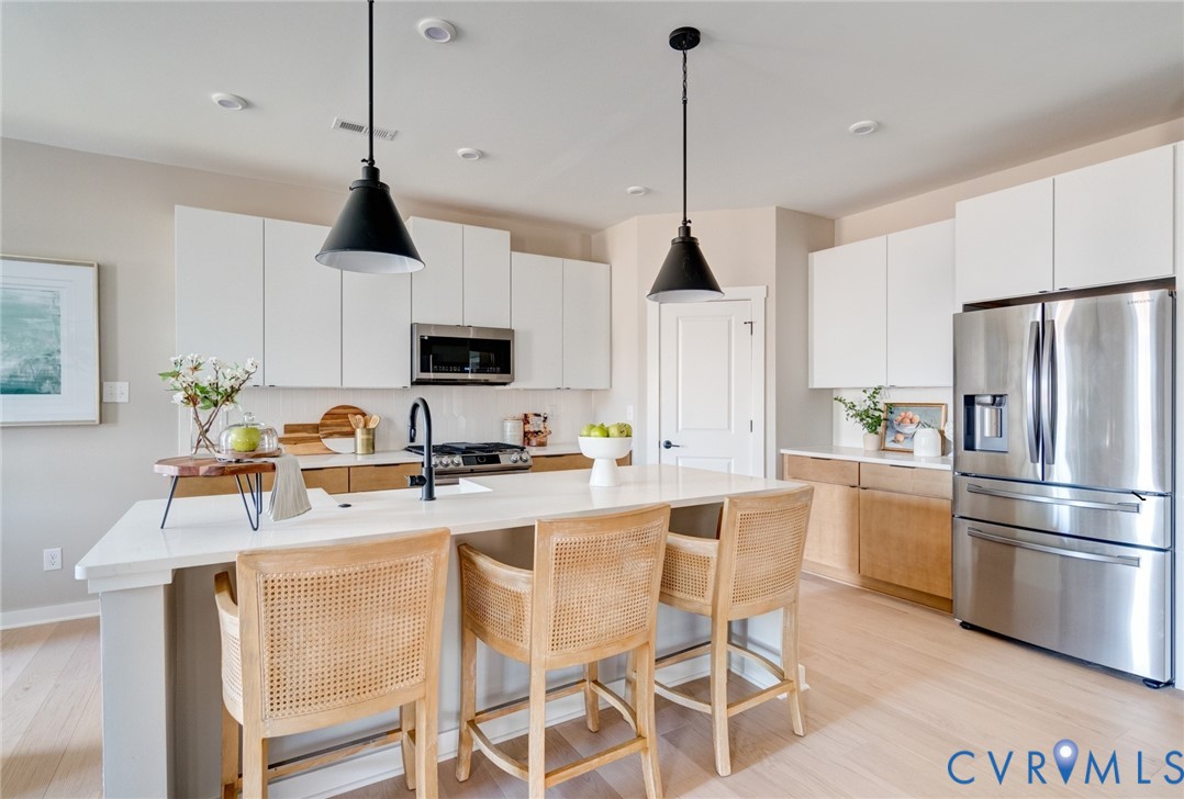 0 Canoe Pointe Loop, Unit 995 Henrico, VA 23238 - Photo 14 of 31 a kitchen with stainless steel appliances granite countertop a sink a stove a refrigerator and cabinets