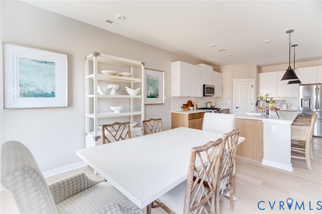 0 Canoe Pointe Loop Henrico, VA 23238 - Photo 20 of 32 a kitchen with kitchen island a stove a table and chairs in it