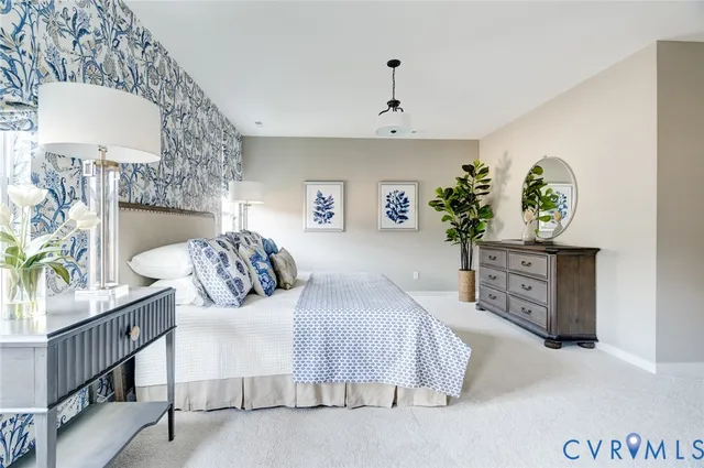 a kitchen with stainless steel appliances a stove a white cabinets and a refrigerator