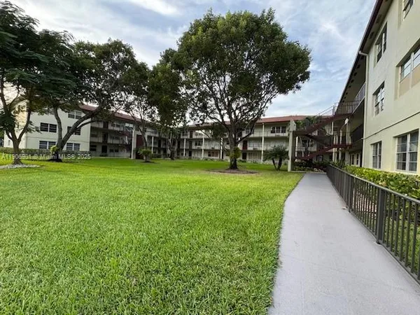a view of a yard with a house in the background