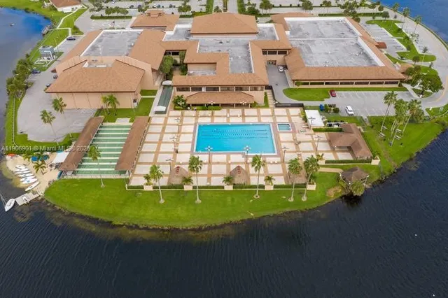 an aerial view of a house with outdoor space pool patio and lake view