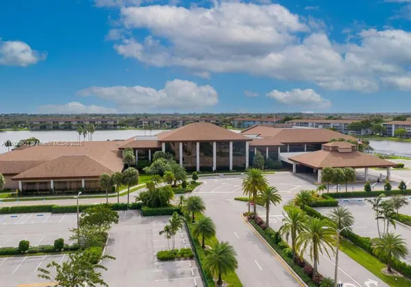 an aerial view of a house with swimming pool garden and lake view
