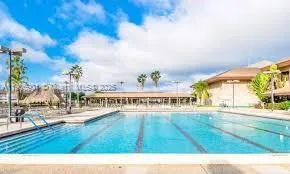 a view of a swimming pool with an outdoor seating