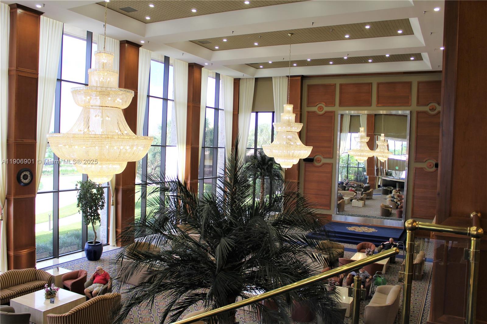 13455 Southwest 3rd Street, Unit 309S Pembroke Pines, FL 33027 - Photo 20 of 23 a room with lots of potted plants and glass windows