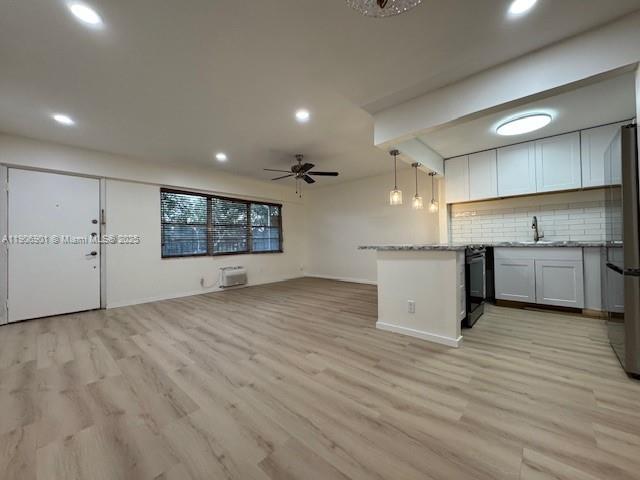 13455 Southwest 3rd Street, Unit 309S Pembroke Pines, FL 33027 - Photo 3 of 23 a view of a kitchen with a sink and wooden floor