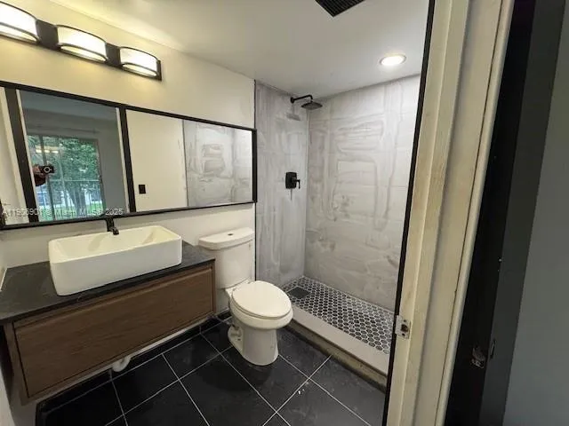 a bathroom with a sink toilet a mirror and shower