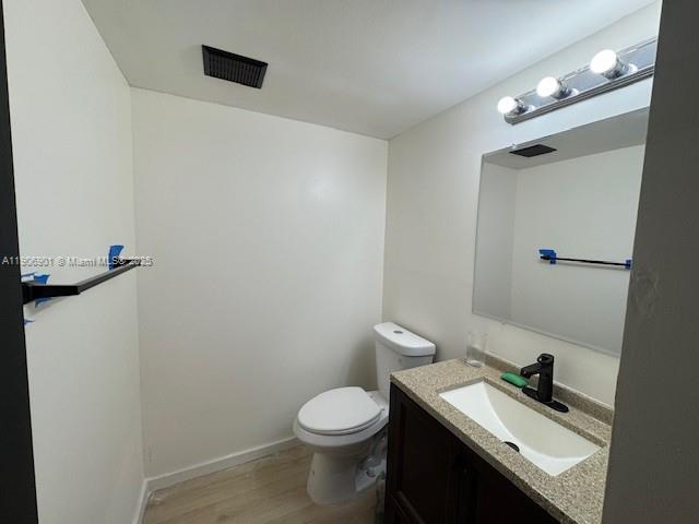 13455 Southwest 3rd Street, Unit 309S Pembroke Pines, FL 33027 - Photo 8 of 23 a bathroom with a sink a toilet and a mirror