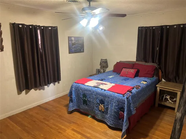 a bedroom with a bed dresser and a window