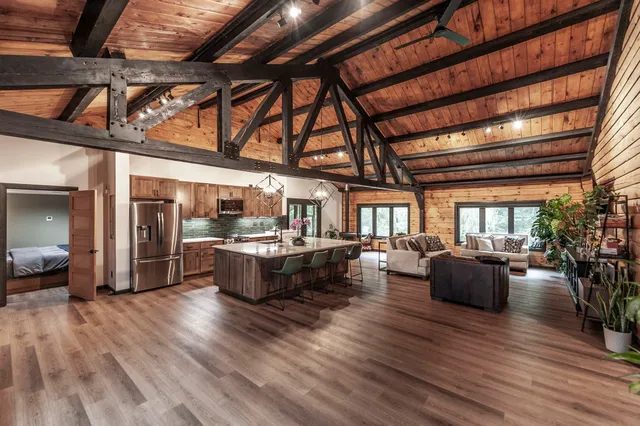 a living room with furniture and wooden floors