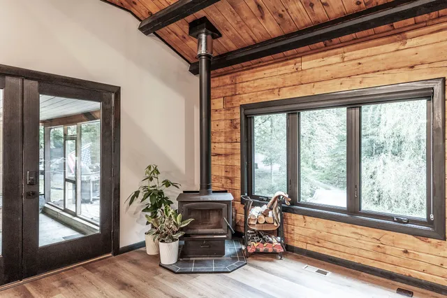 a dining room with wooden floor and a potted plant