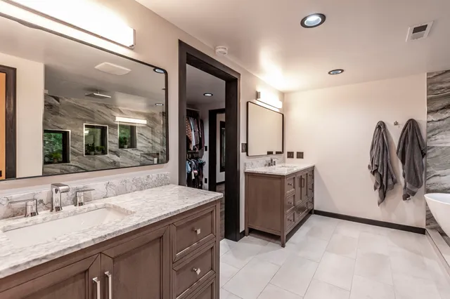 a bathroom with a double vanity sink and a mirror