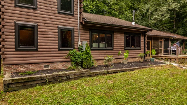 a view of a house with pool and sitting area
