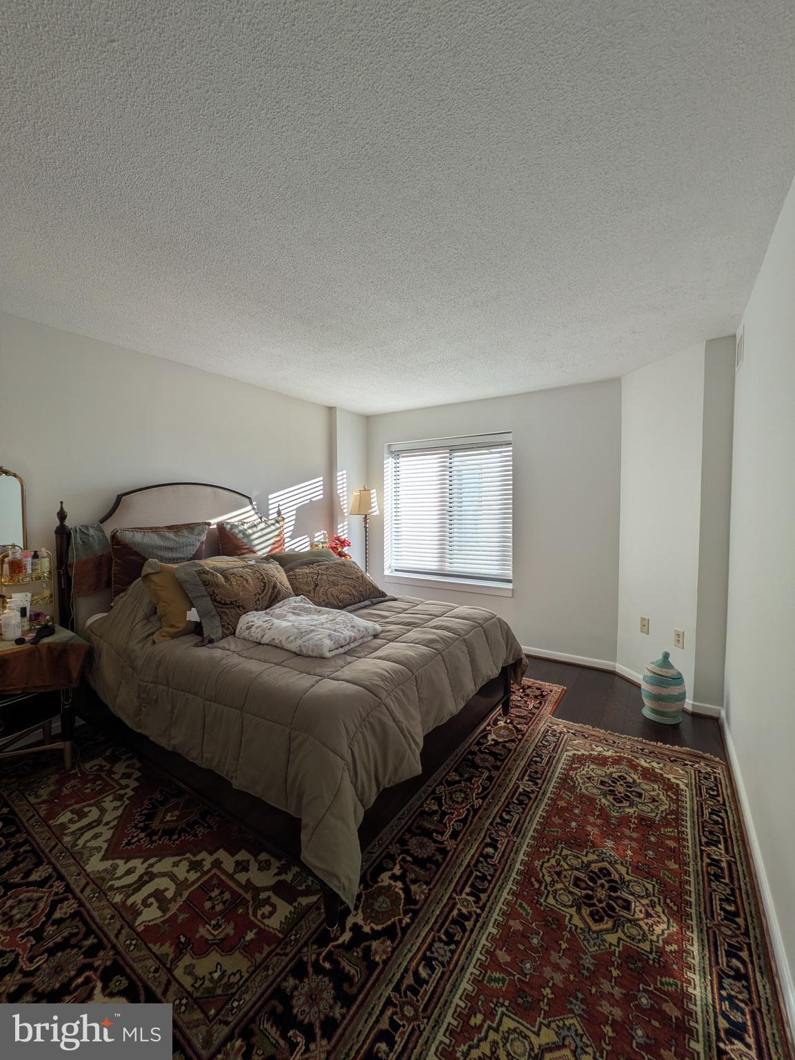 2111 Wisconsin Avenue Northwest, Unit 317 Washington, DC 20007 - Photo 19 of 38 a bed sitting in a bedroom next to a window