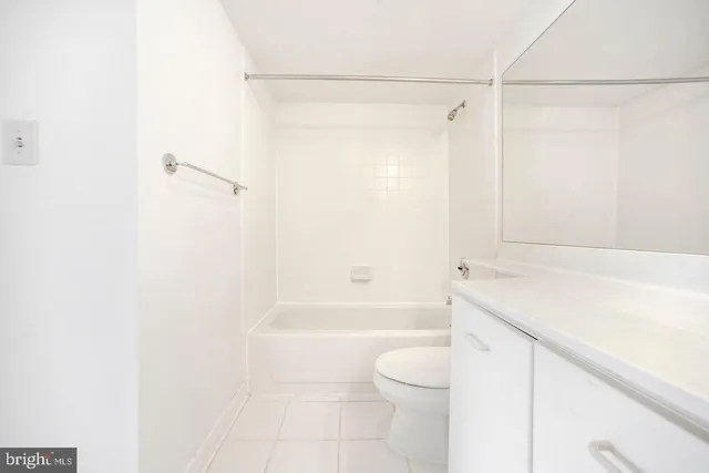 a bathroom with a shower a toilet and a sink