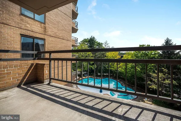 a view of a balcony with wooden floor and fence