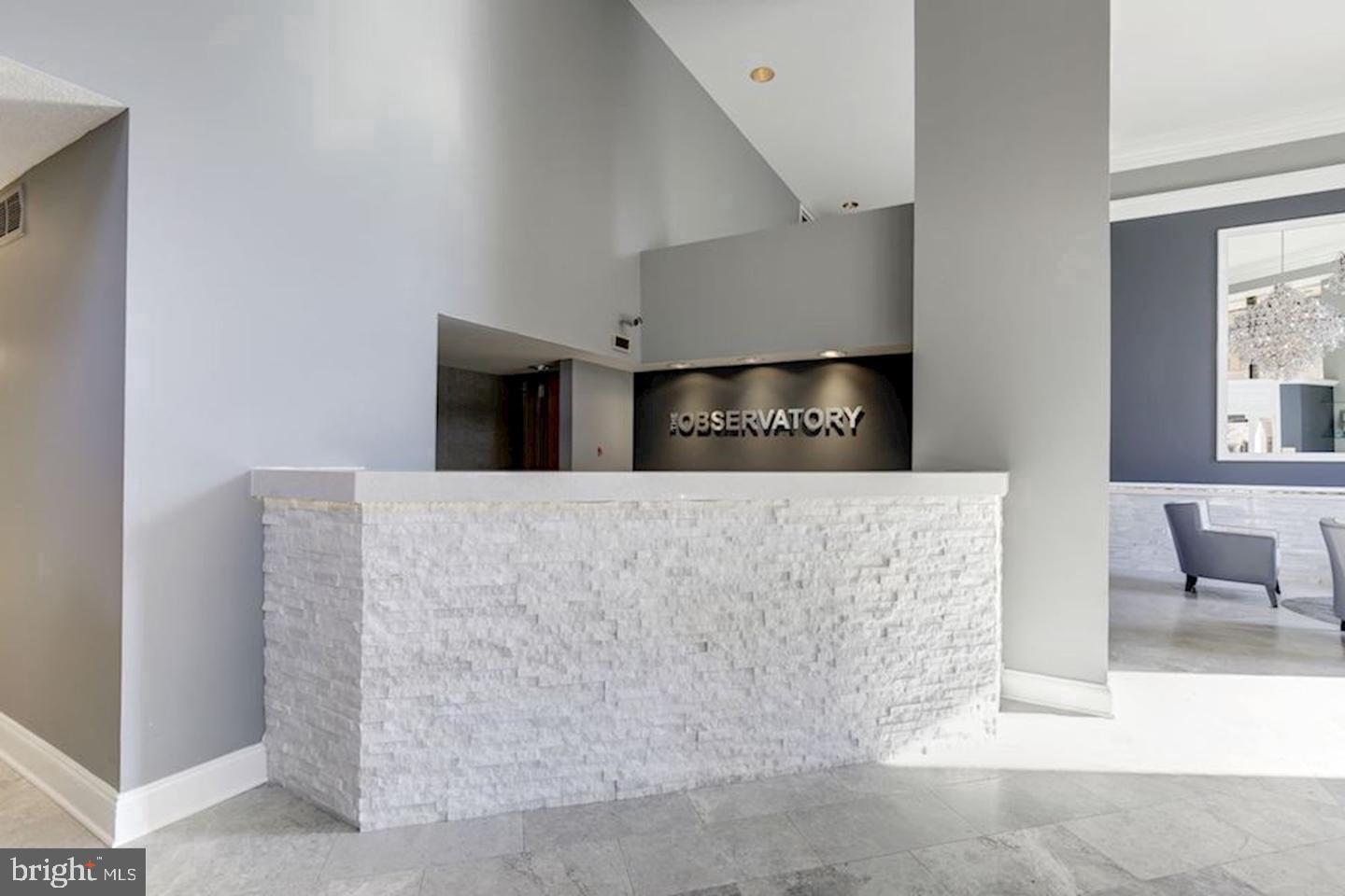 2111 Wisconsin Avenue Northwest, Unit 317 Washington, DC 20007 - Photo 29 of 38 a living room with furniture and a fireplace