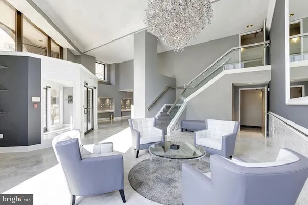 a living room with furniture and a dining table with wooden floor