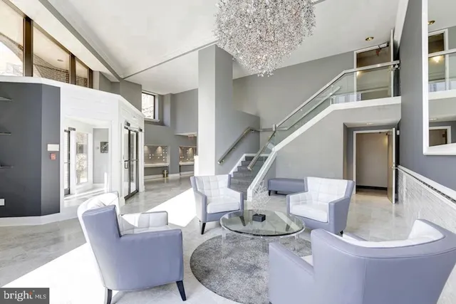 a living room with furniture and a dining table with wooden floor