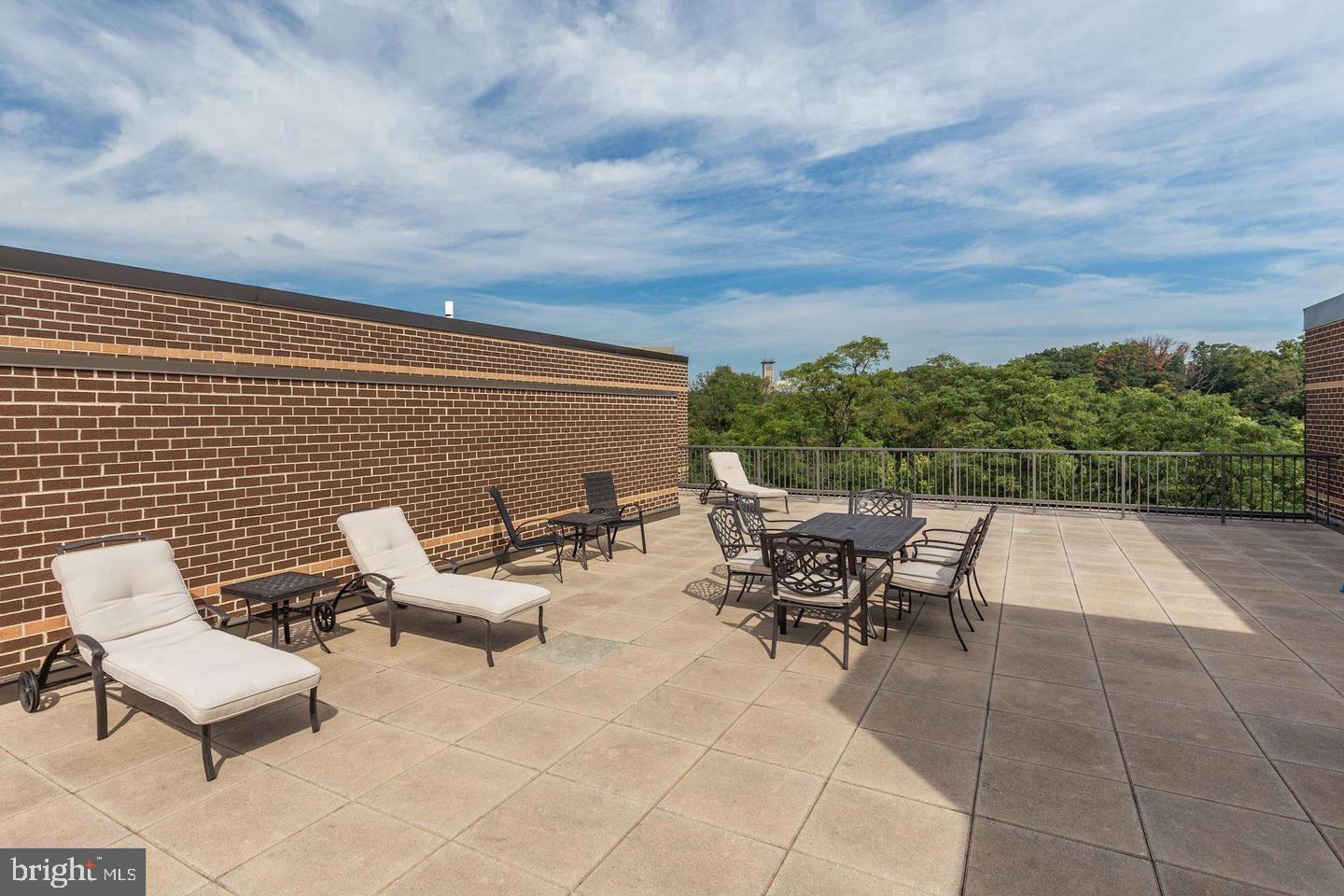 2111 Wisconsin Avenue Northwest, Unit 317 Washington, DC 20007 - Photo 37 of 38 an outdoor sitting area with furniture and city view