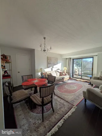 a living room with furniture a rug and a chandelier