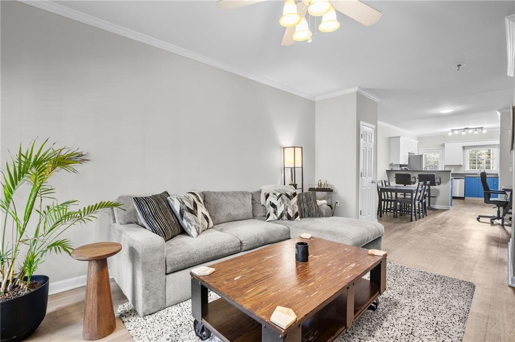 3675 Peachtree Road Northeast, Unit 45 Atlanta, GA 30319 - Photo 6 of 42 a living room with furniture and a chandelier
